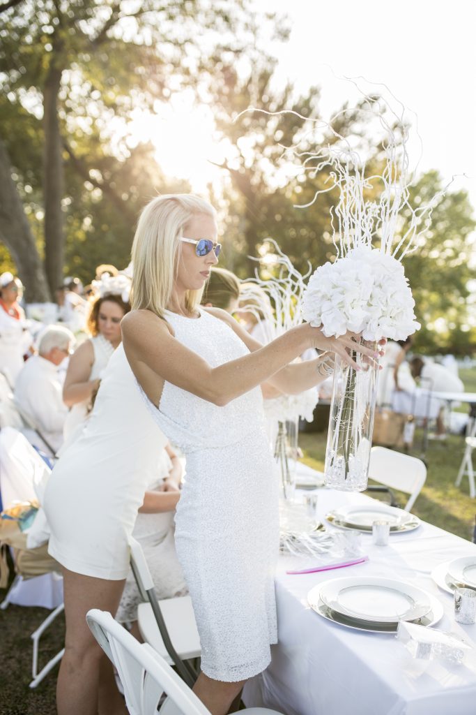 Crafty guests create ornate, white tablescapes for the party. 