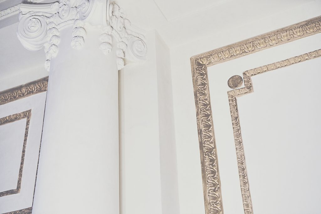 The walls, previously colorful and cherub-covered, have been given a fresh coat of white plaster. 