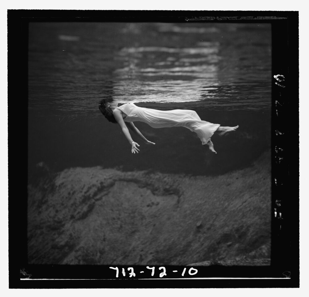From The Art of Bazaar. A model floating in the water at Weeki Wachee Spring, Florida, photographed for the December 1947 issue by Toni Frissell.