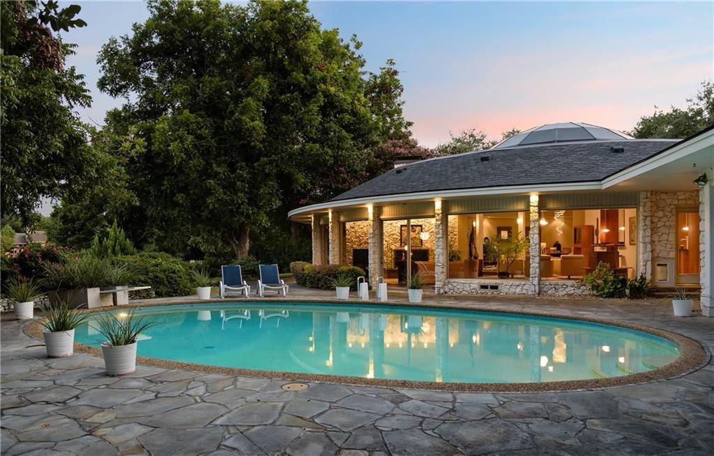 The large property has backyard patios and a circular pool.
