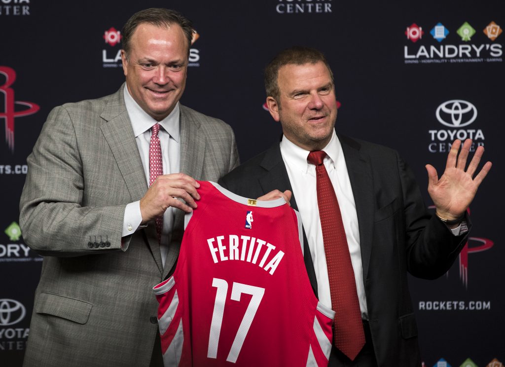 Rockets CEO and Tilman Fertitta hold up his new No. 17 jersey on introduction day.