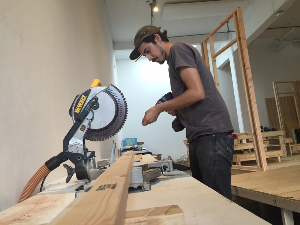 Artpace studio technician Anthony Rundblade lends a hand to help make a tight deadline. 