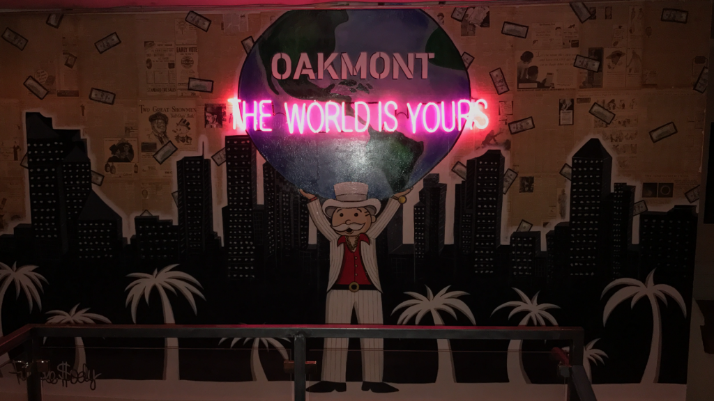 The venue features several pieces of Mr. Moneybag artwork, tying in The Wolf of Wall Street  theme. 