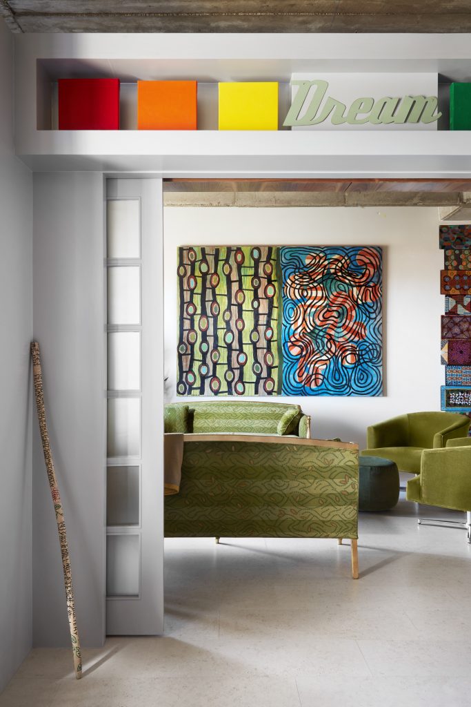 In the corner, Roosevelt Wilkerson's Ten Commandments Stick, 2010. Above door, Pam Nelson's Color Spectrum/Dream, 2017, was created in honor of Robert A. Wilson. On far wall, Pam Nelson's Stem Cells, 2002. 