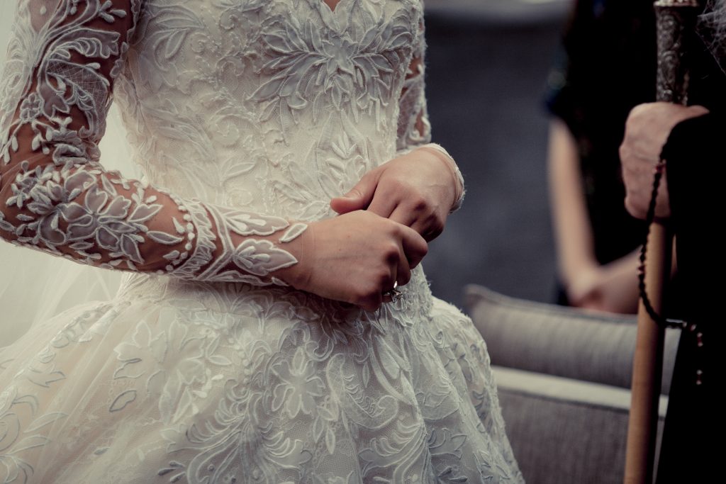 The bride wore a Ysa Makino lace gown from Mia Bridal, with a long-sleeved lace overlay for the reception.