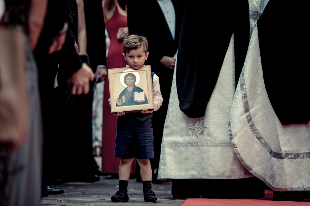 Sebastian, Guillermo's son from a previous marriage, walks down the aisle with an icon of Jesus.