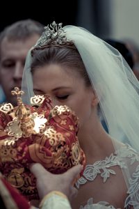 In a Russian Orthodox ceremony, the placing of crowns atop the bride and groom's heads symbolizes the union (rather than the exchanging of rings, which symbolizes the betrothal).