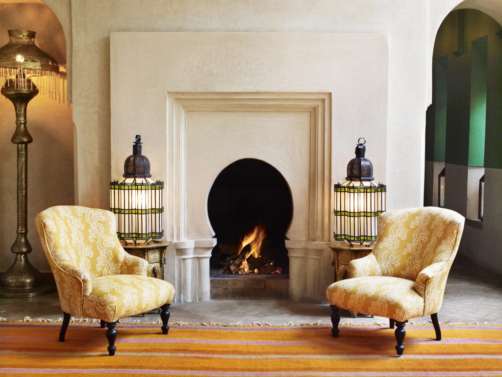 Bright orange and pink have never felt as soothing as they do next to this stunner of a fireplace