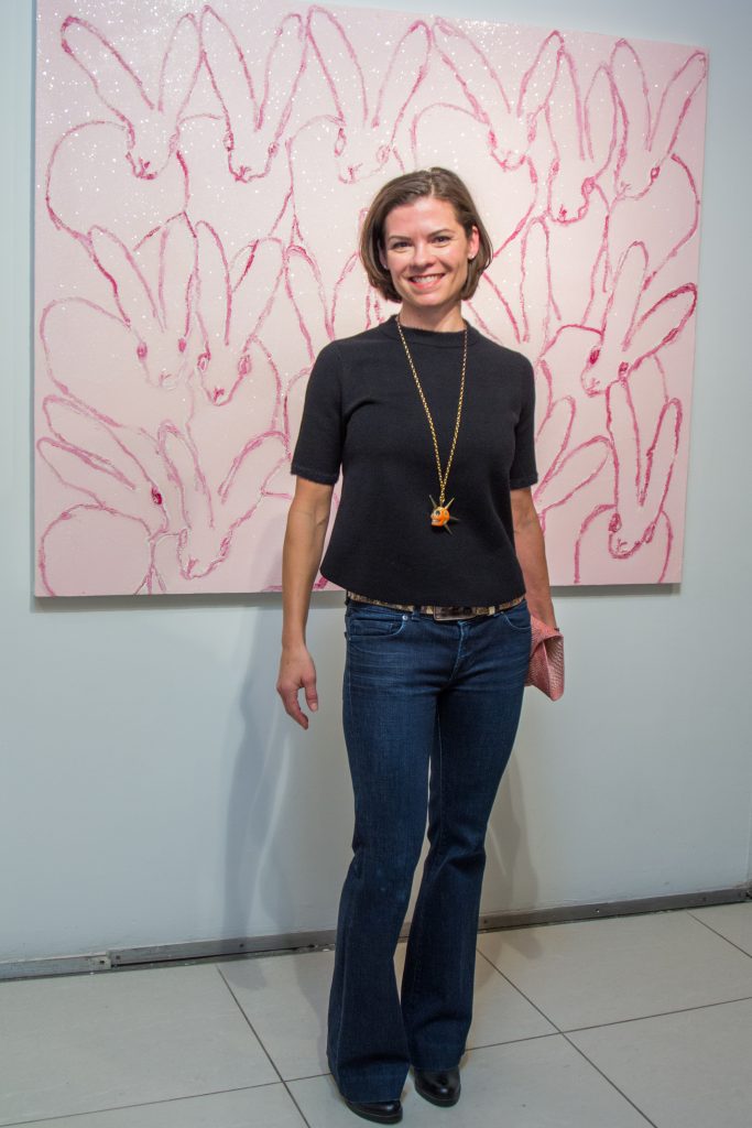 Kelley Devine admires a Hunt Slonem canvas at Laura Rathe Fine Art, Houston (Photo by Lizette Belen Soto) 