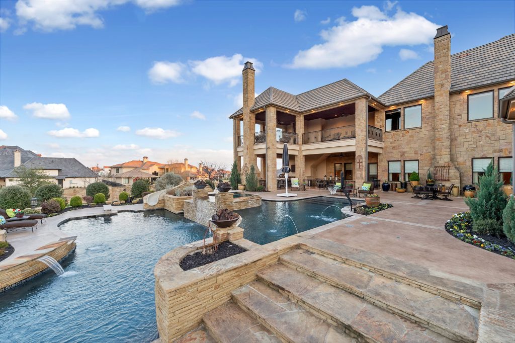 The resort-style pool has a diving board and slide. 