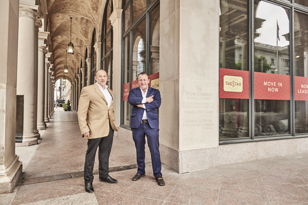 Benjamin Berg and The Star developer, Kip Platt, stand outside the historic Texaco building-turned-luxury-apartment-tower. 