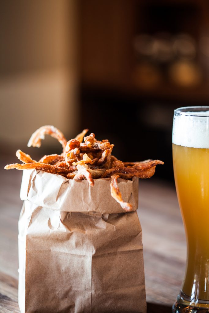 The Hay Merchant is a casual counterpart to Shepherd's other restaurants, offering up eats like sweet & spicy pig ears in a paper bag. 