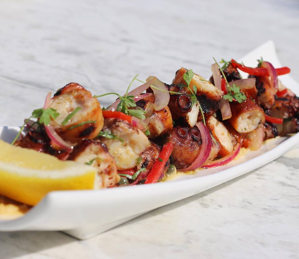 Ouzo Bay offers charcoal-grilled octopus tossed with sweet onions and red peppers. 