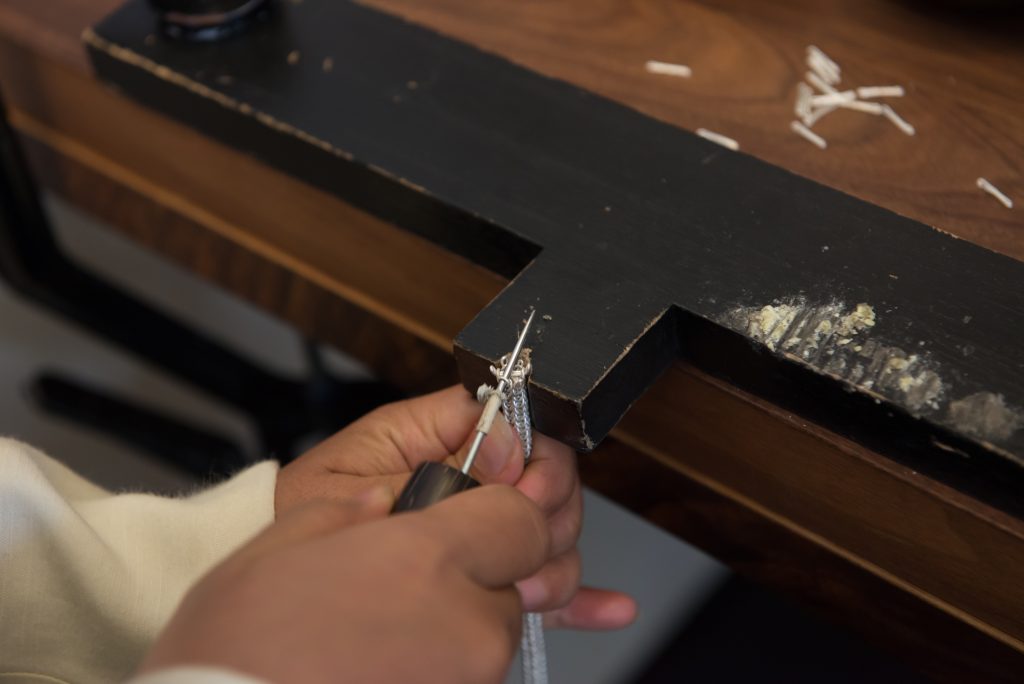 Detail of a John Hardy artisan weaving the iconic chain.