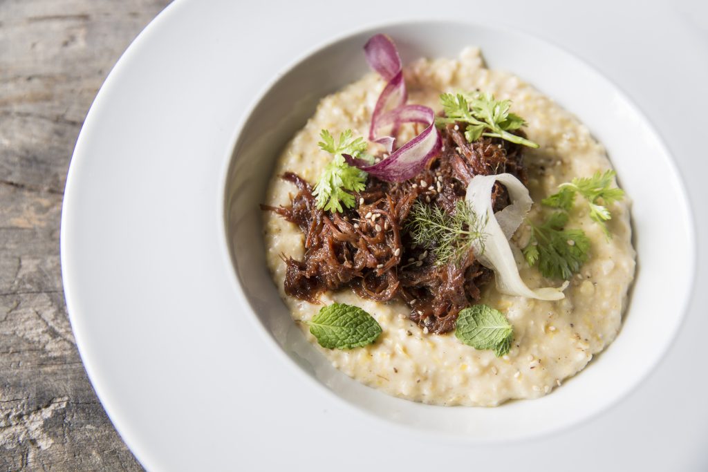 Underbelly's slow cooked pork and grits feature Circle S Farms Hickory King Grits, grown exclusively for Underbelly. 