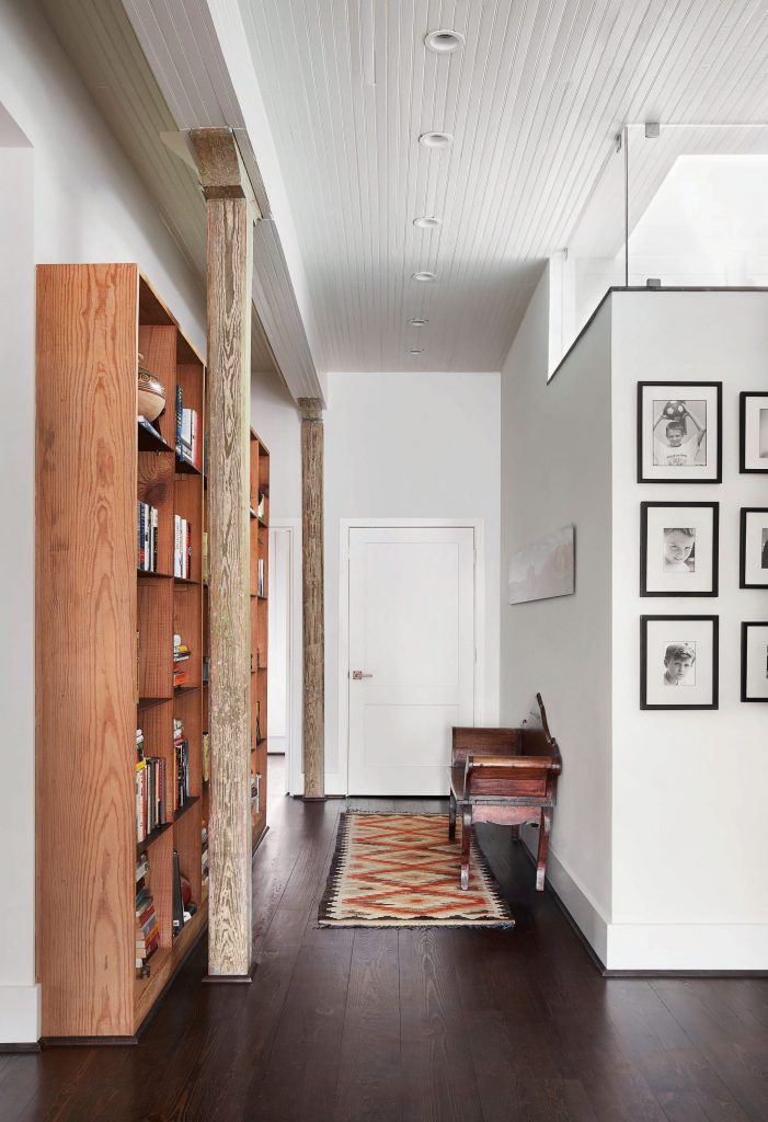 Bookshelves made from reclaimed wood from a demolished neighborhood building. Bench from Nicaragua. Middle Eastern rug. 