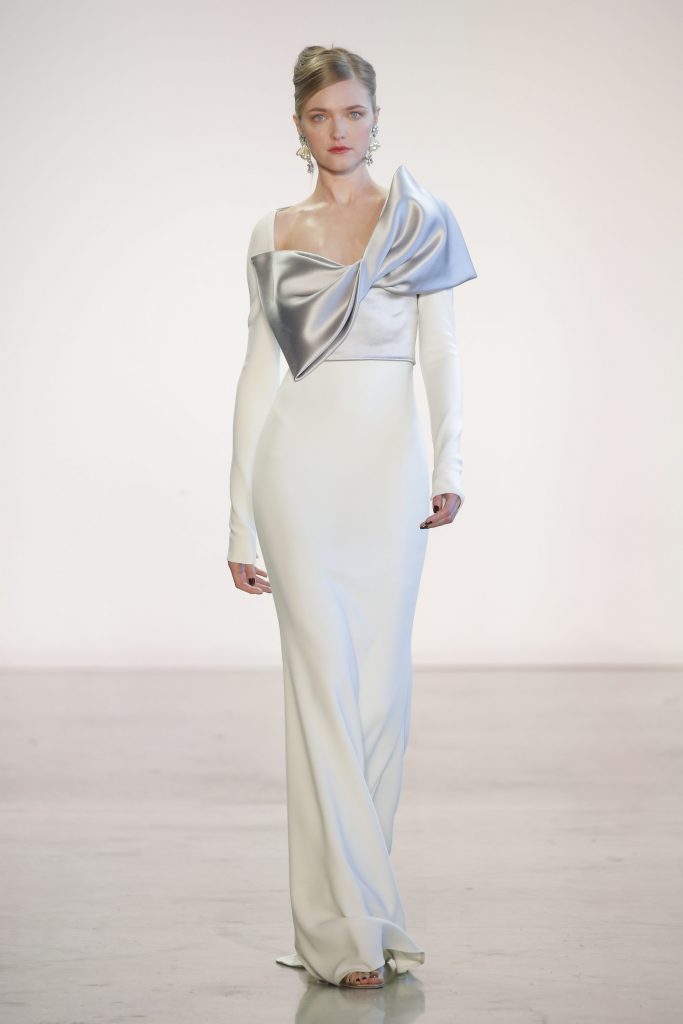Badgley Mischka white crepe and dove satin bow evening gown.