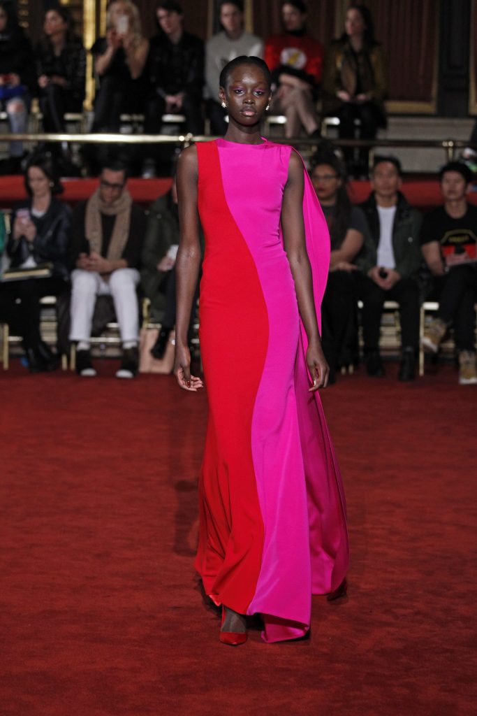 Christian Siriano !ueen red and royal fuchsia side drape gown.