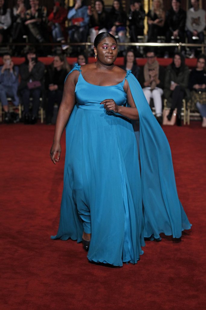 Danielle Brooks models a Christian Siriano peacock turquoise chiffon slip gown.