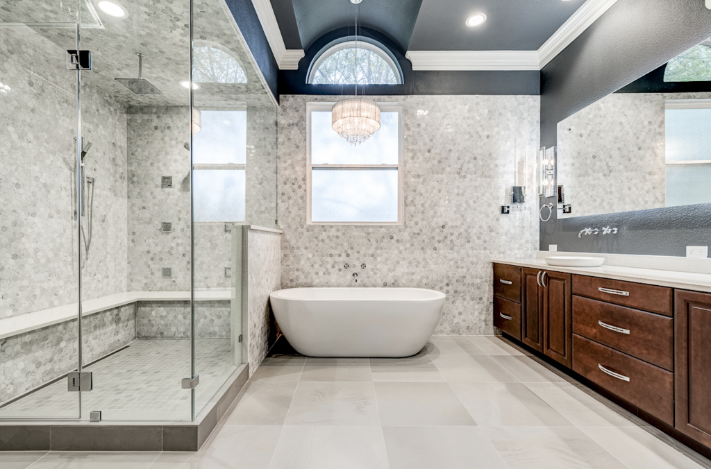 Luxury bathroom remodel with accent marble tiles, steam shower floor to ceiling glass door, liner drain, custom double vanity with extra deep drawer for hidden day to day toiletry and bathroom appliances.