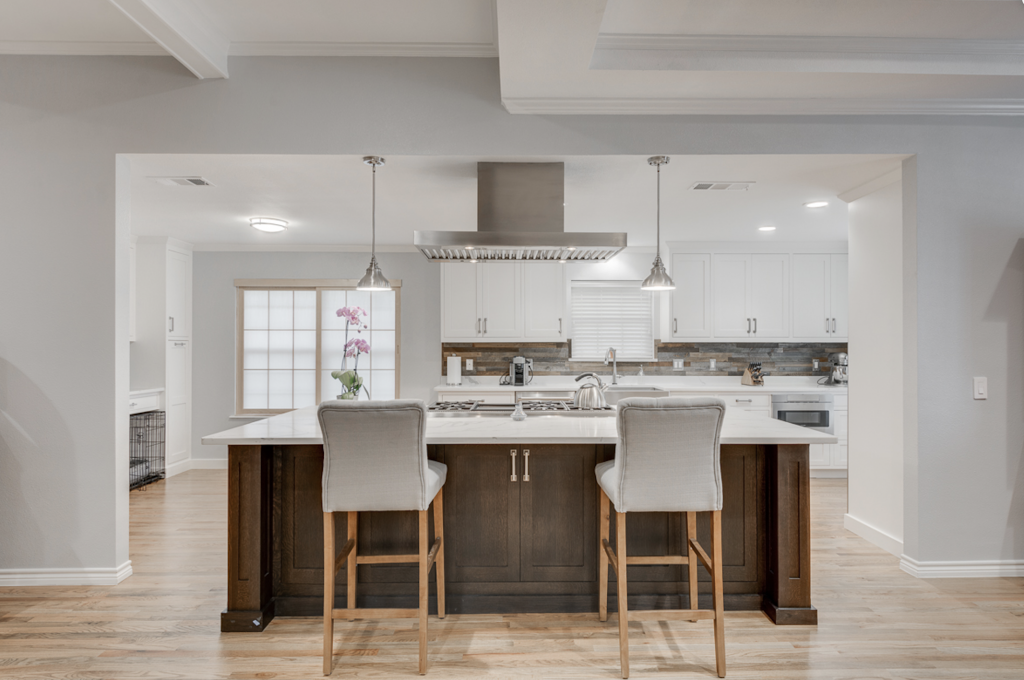 Contemporary kitchen design with custom white cabinetry and recycled wood backsplash make this Joseph & Berry kitchen remodel so unique. 