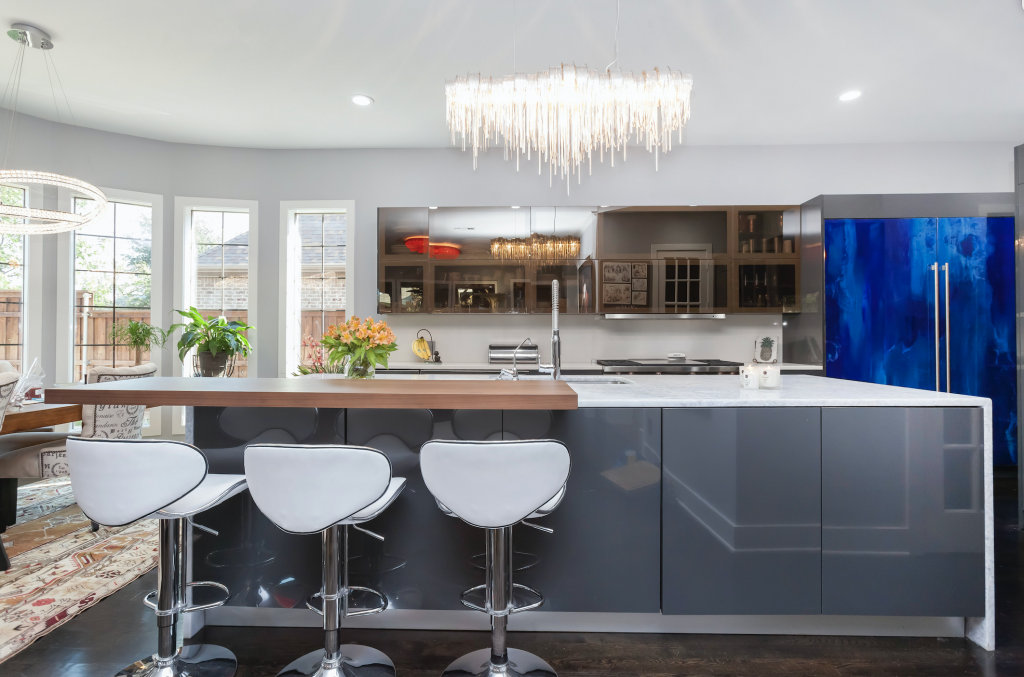 This modern kitchen remodel by Joseph & Berry, brings unique designs and functionality together with custom-made electronically operated glass doors. 