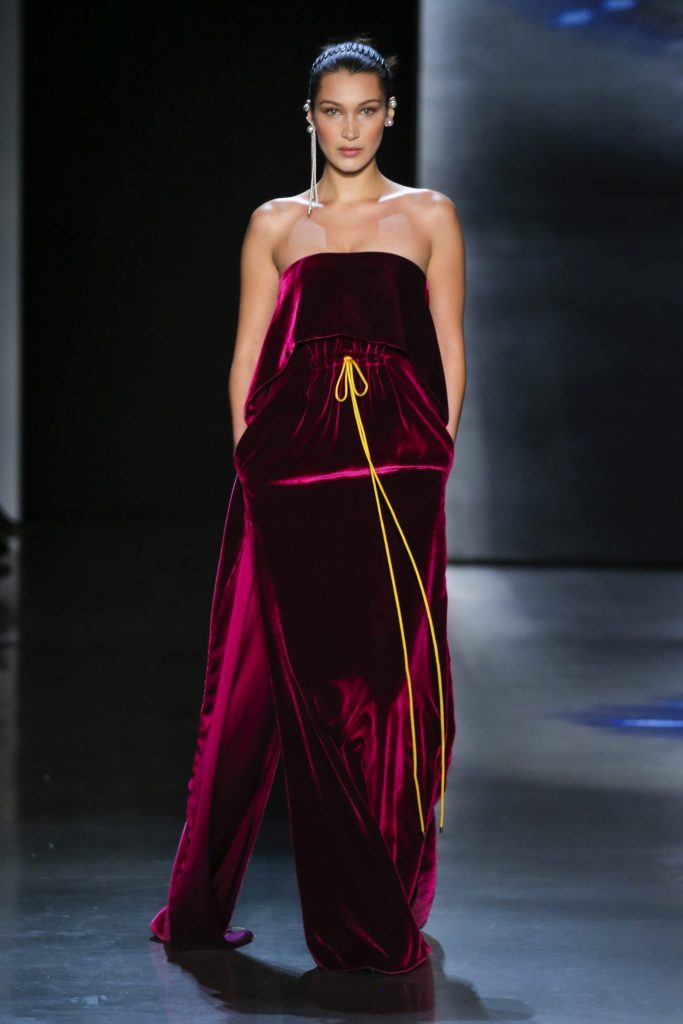 Prabal Gurung raspberry panne velvet strapless cascade cape gown with gold cording drawstring.