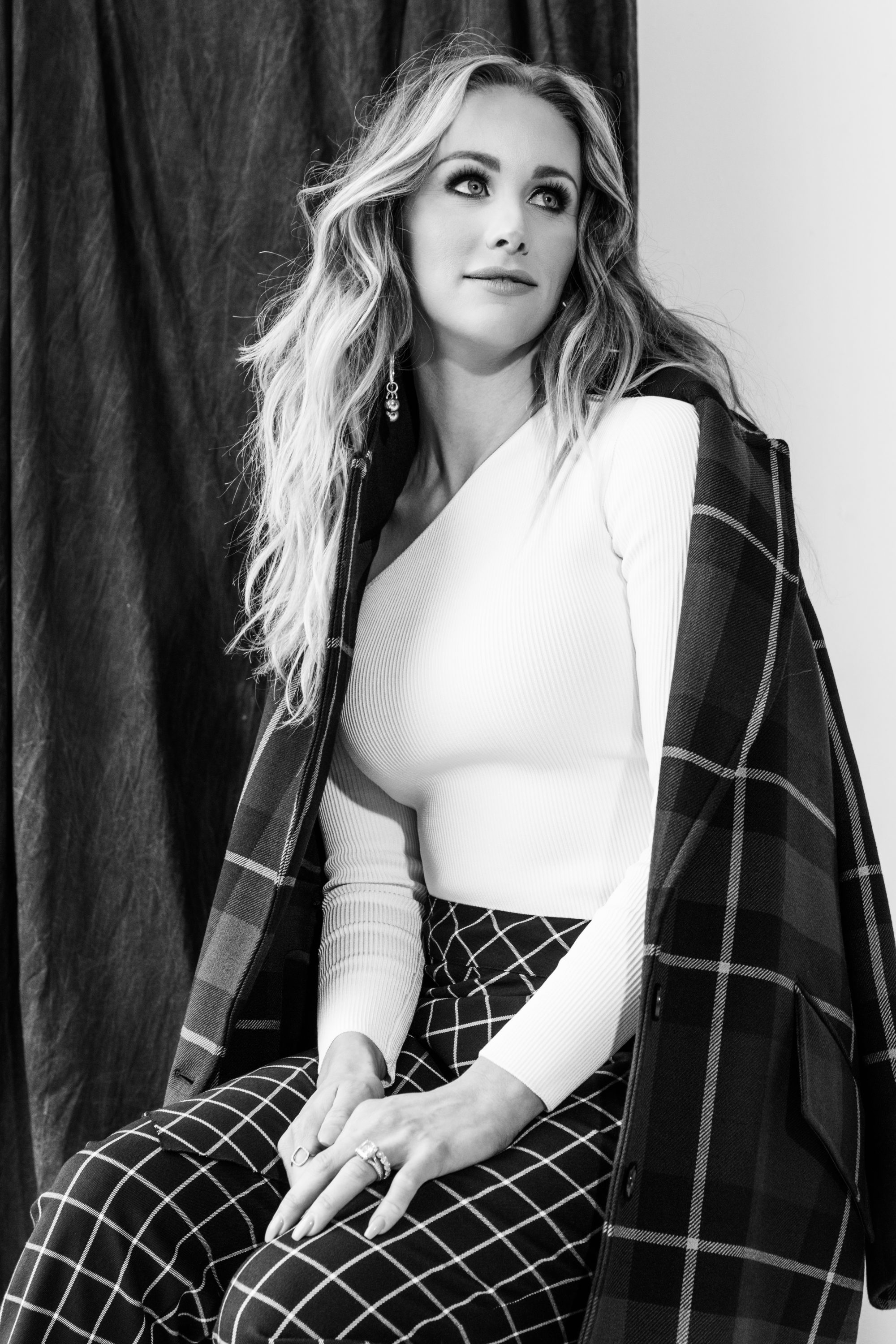 Candice Romo wearing a Chushnie et Ochs bodysuit, Burberry coat, Robert Rodriguez pants, and Yves Saint Laurent pumps, all at Nordstrom NorthPark Center.
