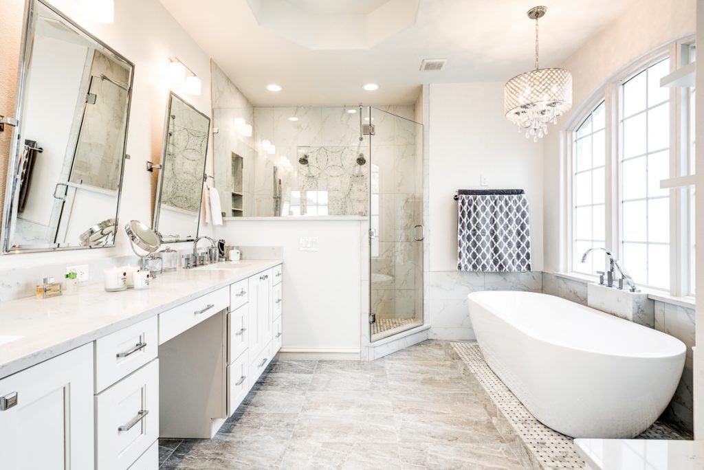 This luxurious master bath by Joseph and Berry is the perfect example where classic meets modern. With a crystal chandelier over the tub and marble mosaics on the floor, you get a total spa experience