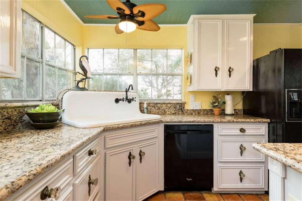 The home's kitchen features an elegant farmhouse sink. 