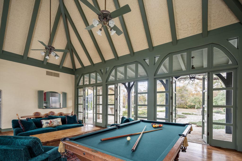 The game room overlooks the lush property.