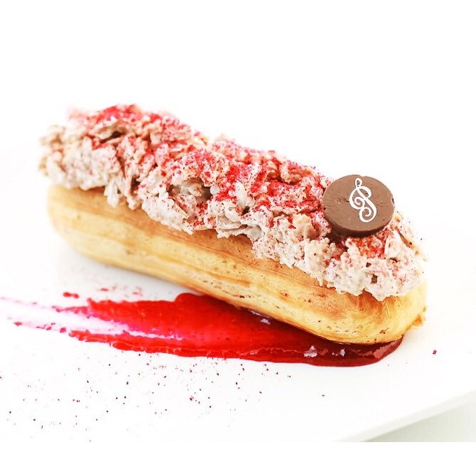 Cafe Poetes specializes in both classic eclairs like this raspberry one and savory options like salmon or brisket. 