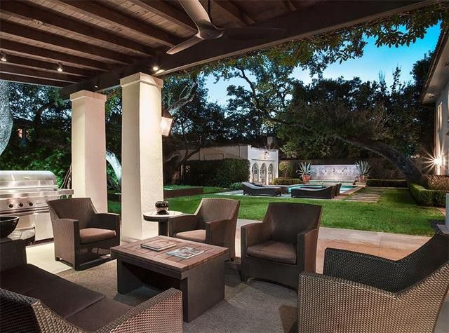 The covered patio looks out on sweeping live oaks. 