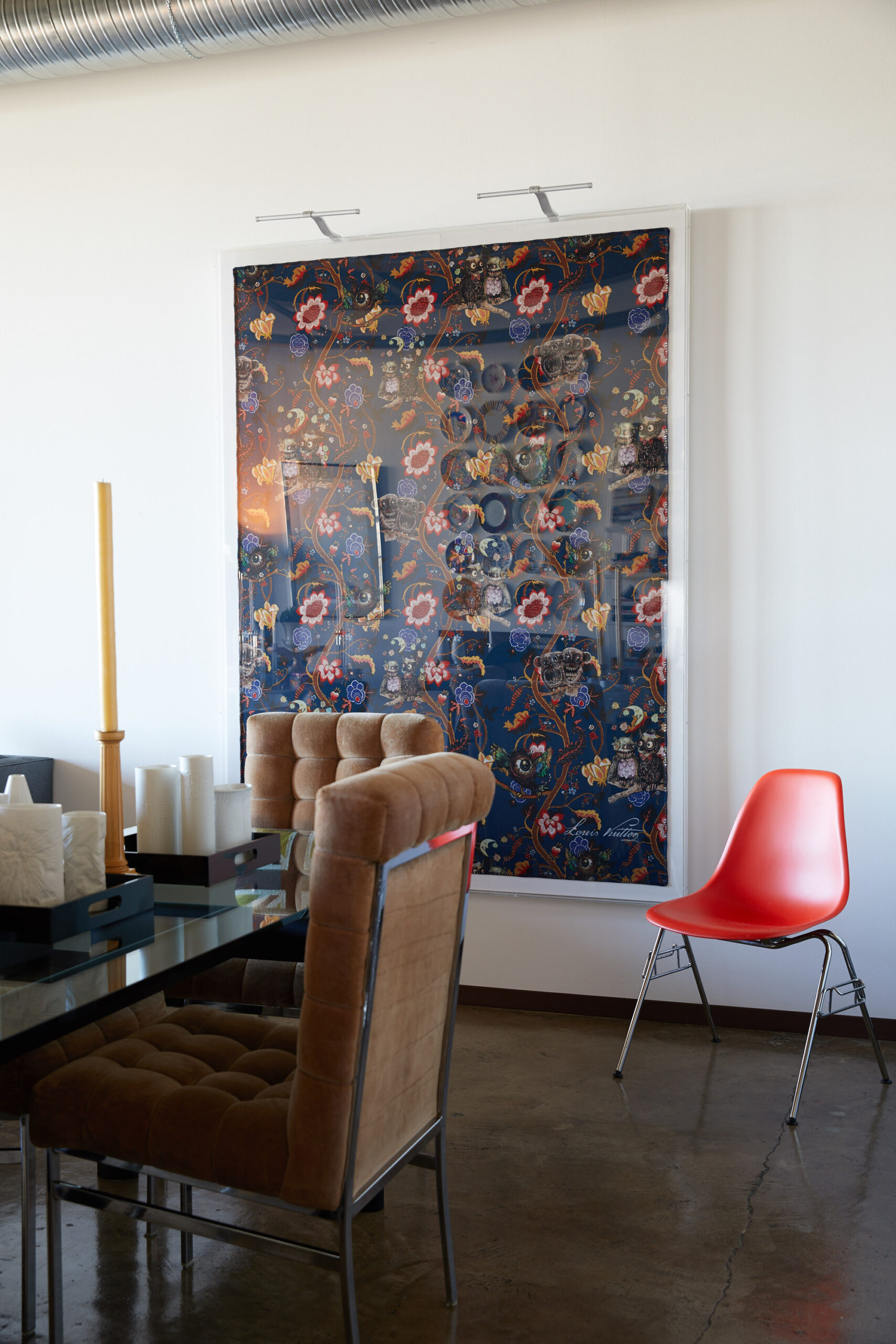 Cassina LC6 table from Sunset Settings, Houston. Vintage Pierre Cardin chairs, 1970, from Vinya. Framed, Chapman Brothers’ Garden in Hell blanket for Louis Vuitton Fall/Winter 2013. Eames side chair for Herman Miller.
