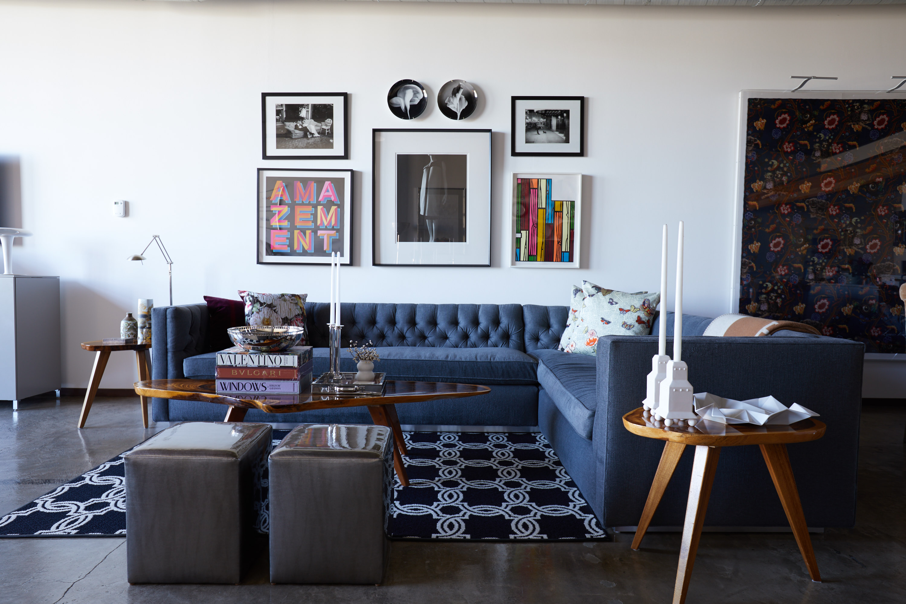 At right, Stanley Tigerman porcelain candlesticks for Swid Powell. Alice Cottrell-designed sectional and ottomans made by Kisabeth. Artwork by Thurston Hopkins, Robert Mapplethorpe, Kurt Hutton, Ben Eine, Hiroshi Sugimoto, Richard Woods.