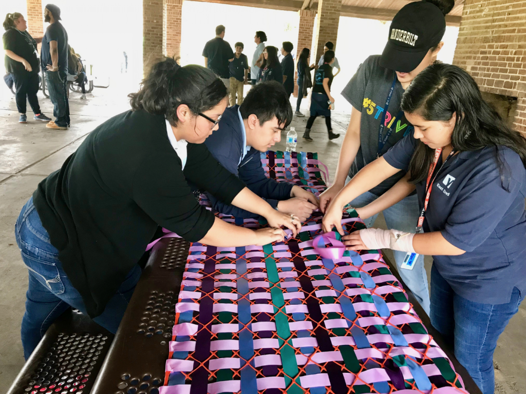 "Color Bursting" in process thanks to YES Prep students. The colorful vests and skirts take over Hermann Park, on view March 25 through May 20.