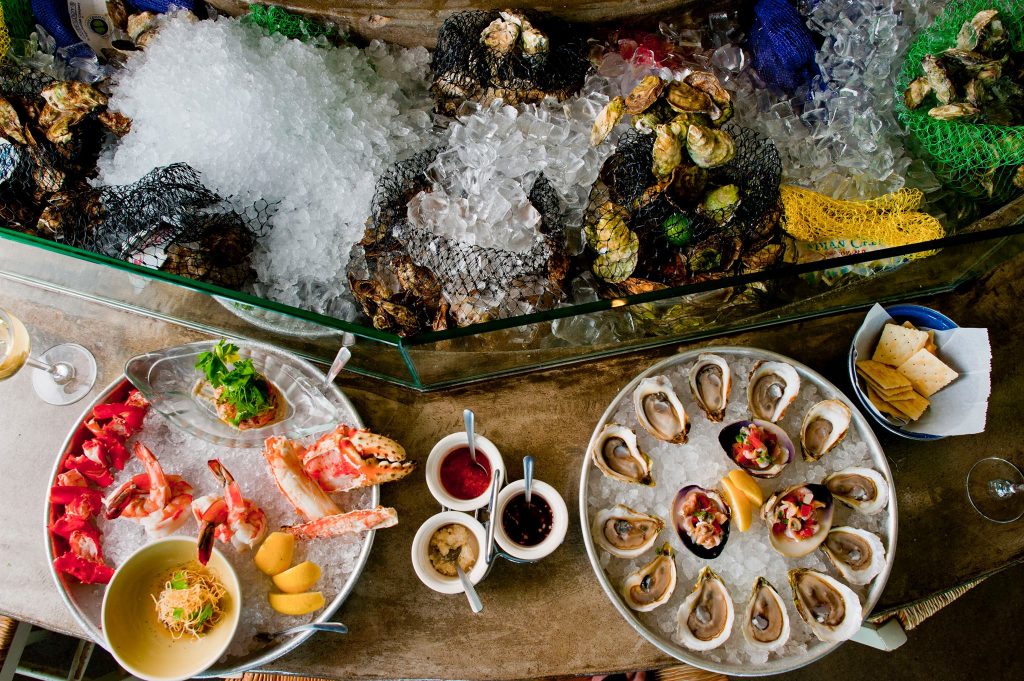 Perla's is famed for its juicy oysters, flown in from both coasts. (Photo by Perla's Seafood & Oyster Bar.)