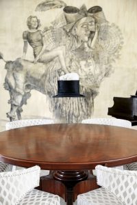 Wolfe Von Lenkiewicz’s "Dora", 2009, and Polly Morgan’s "White Rabbit on a Top Hat", 2007. Chairs from Dean Martin’s Palm Springs estate.
