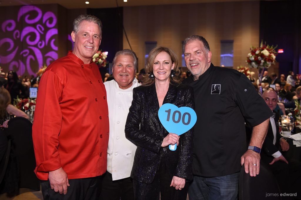 Terri Gallagher surrounded by Chefs Richard Chamberlain, Jim Severson and Kent Rathbun