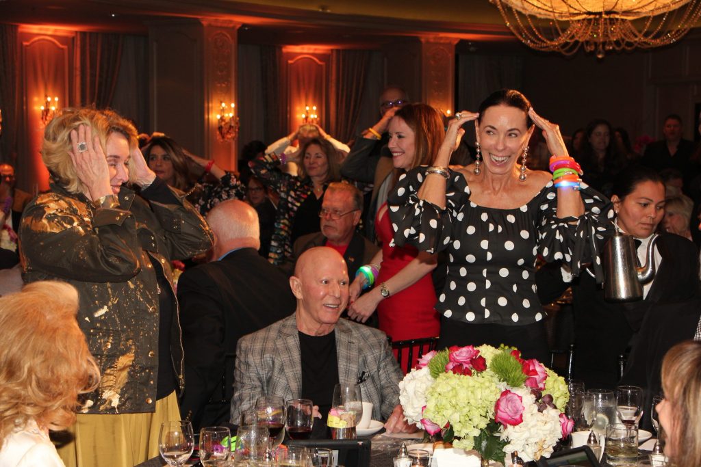 Lester & Sue Smith joining in Heads or Tails at the ESCAPE Family Resource Center Celebrity Serve at Hotel ZaZa in April.