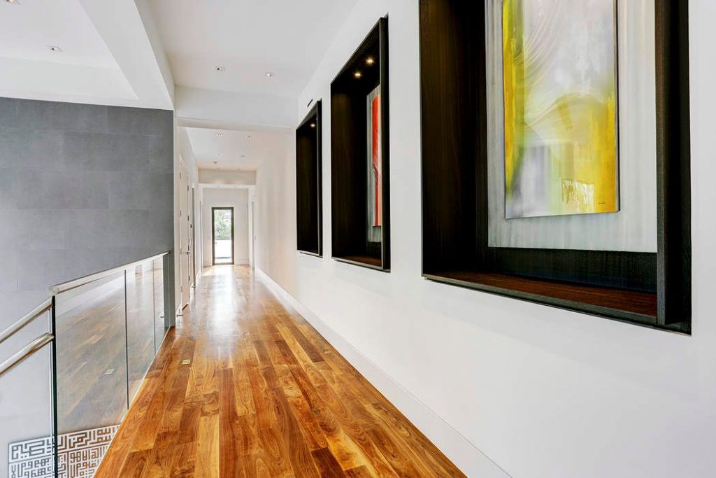 The hard wood floor is stunning in this long hallway. 