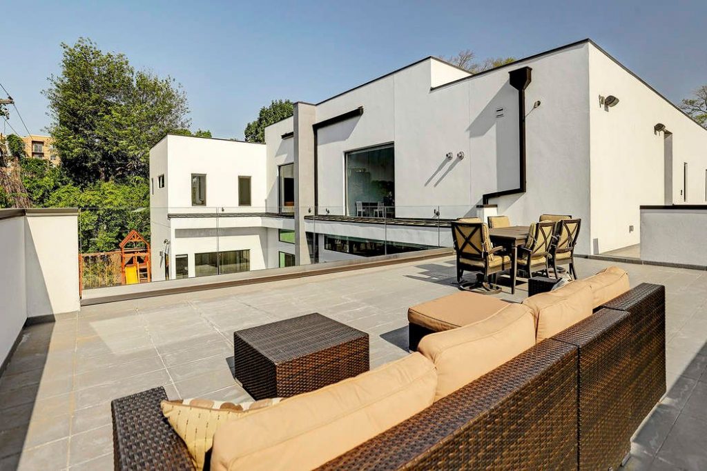 A balcony overlooks the pristine pool. 