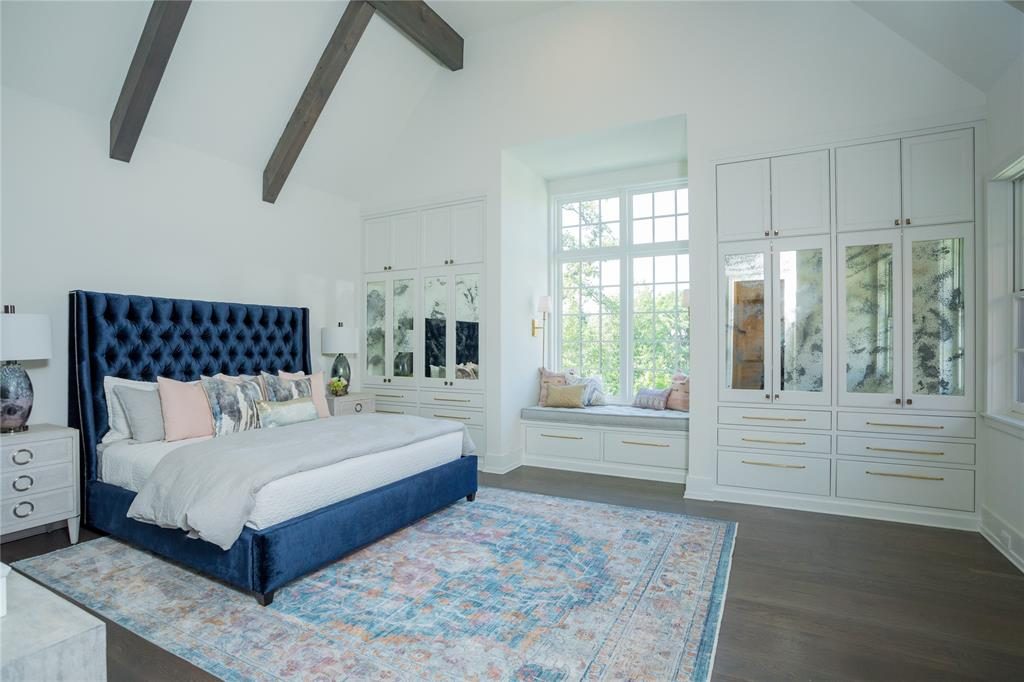 The fifth bedroom is cozy with built-in drawers and window seating with storage underneath. 