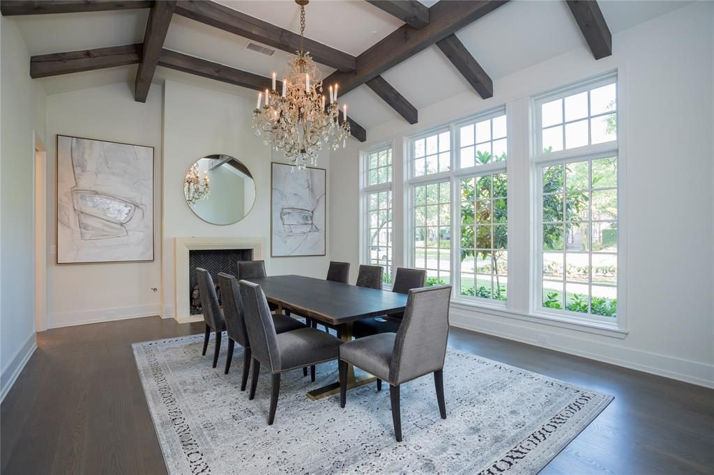 The oversized crystal chandelier in the formal dining room was imported from France, fitting with the tall windows. 