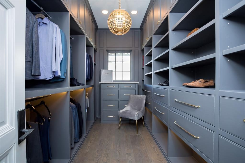 His closet has shelving with LED strip lights. 