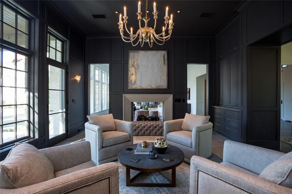 The lounge has a cozy two-way masonry fireplace and French doors to an outdoor room. 