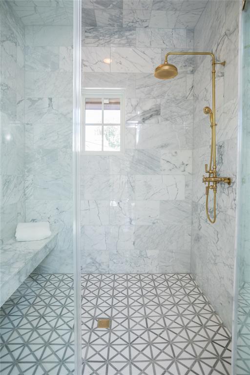 The luxurious walk-in showers gleam with Calcutta marble walls.