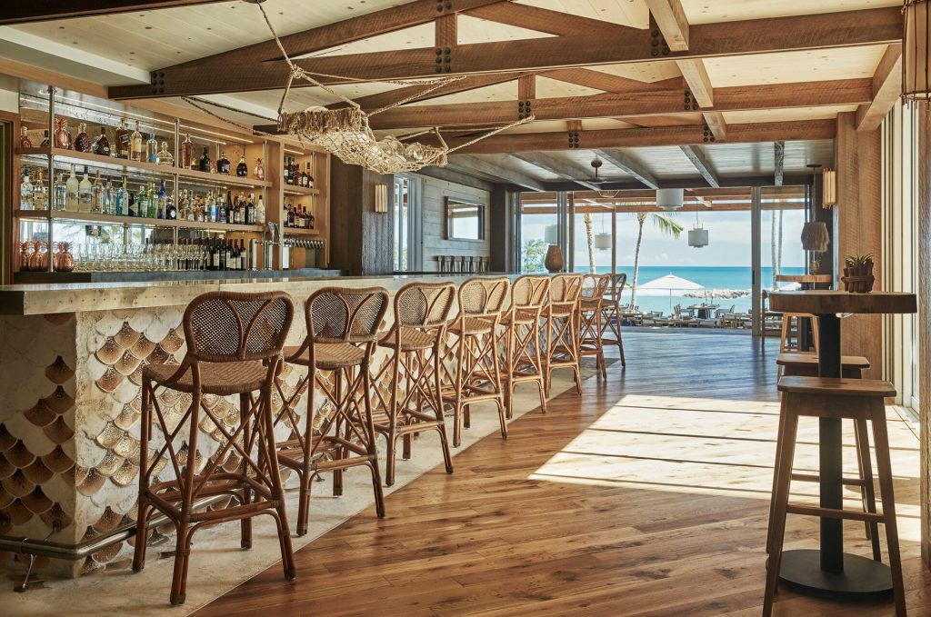 The restaurant has a large, custom bar with island-inspired elements. 