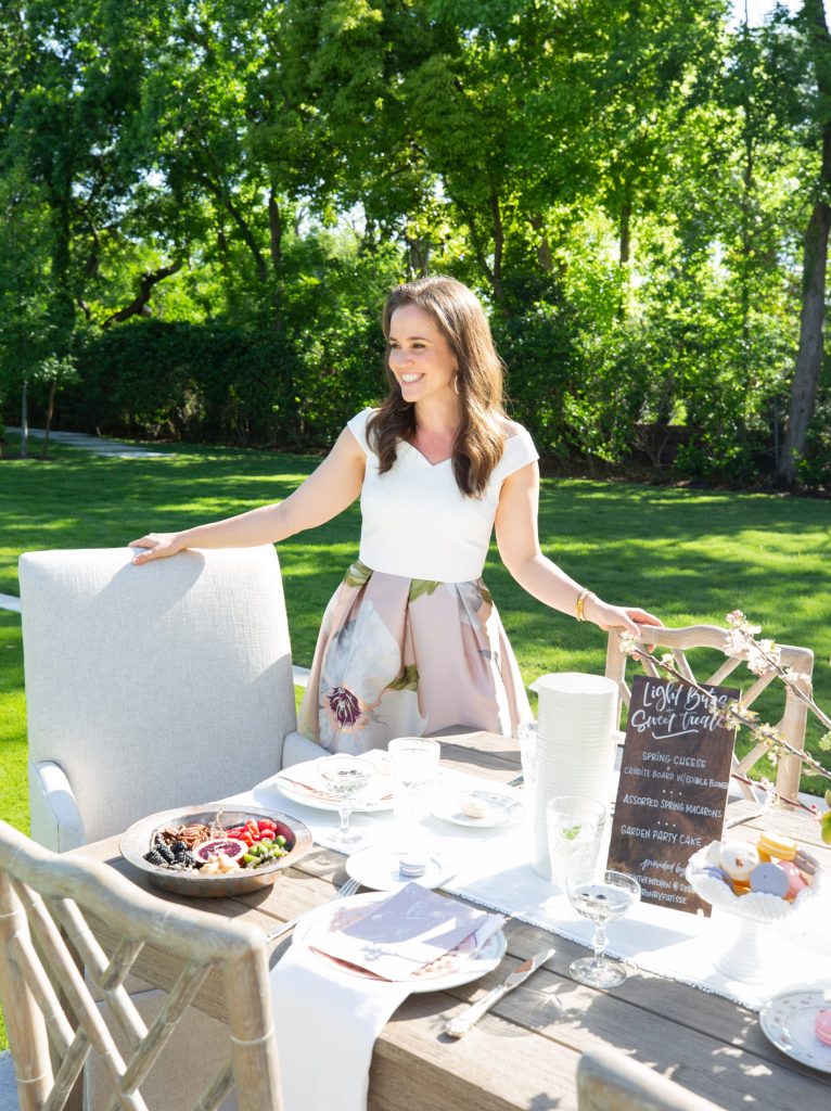 Marie Flanigan takes a seat at the al fresco table at her client's home.
