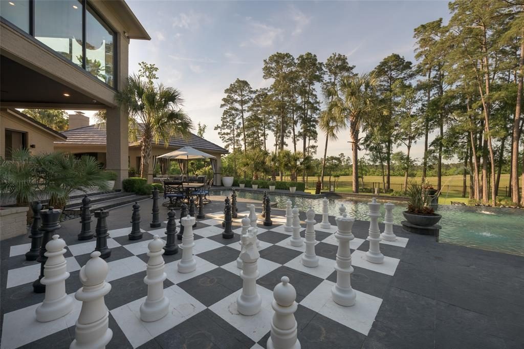 An oversize chess board is just one of the many outdoor amenities, like the al fresco kitchen. 